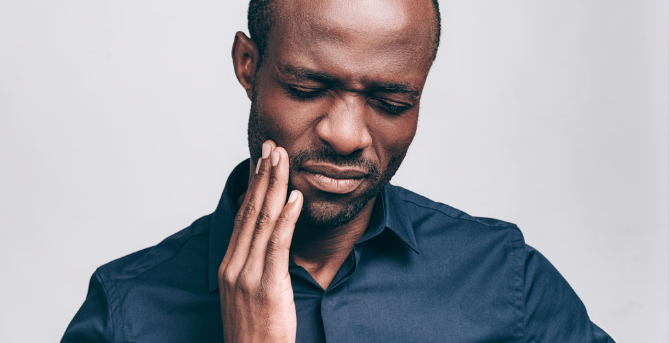 Man experiencing tooth pain